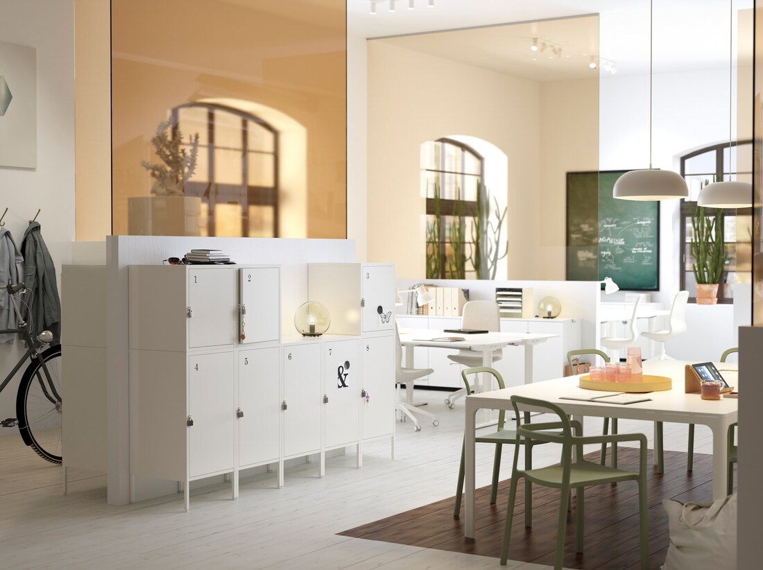 A medium sized, white and beige office workspace with practical, lockable, IKEA HÄLLAN white storage cabinets.