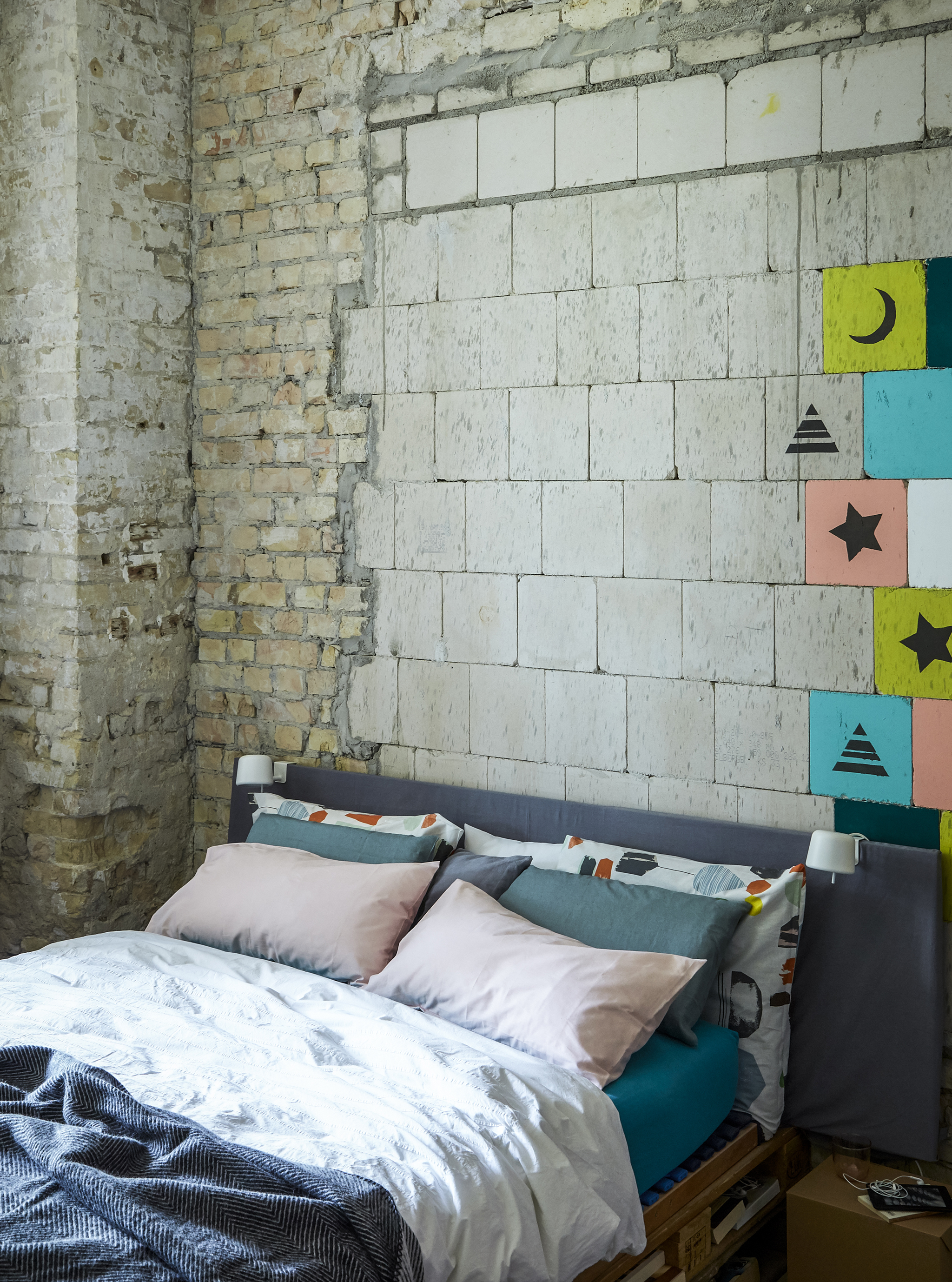 A bedroom with exposed brick wall.