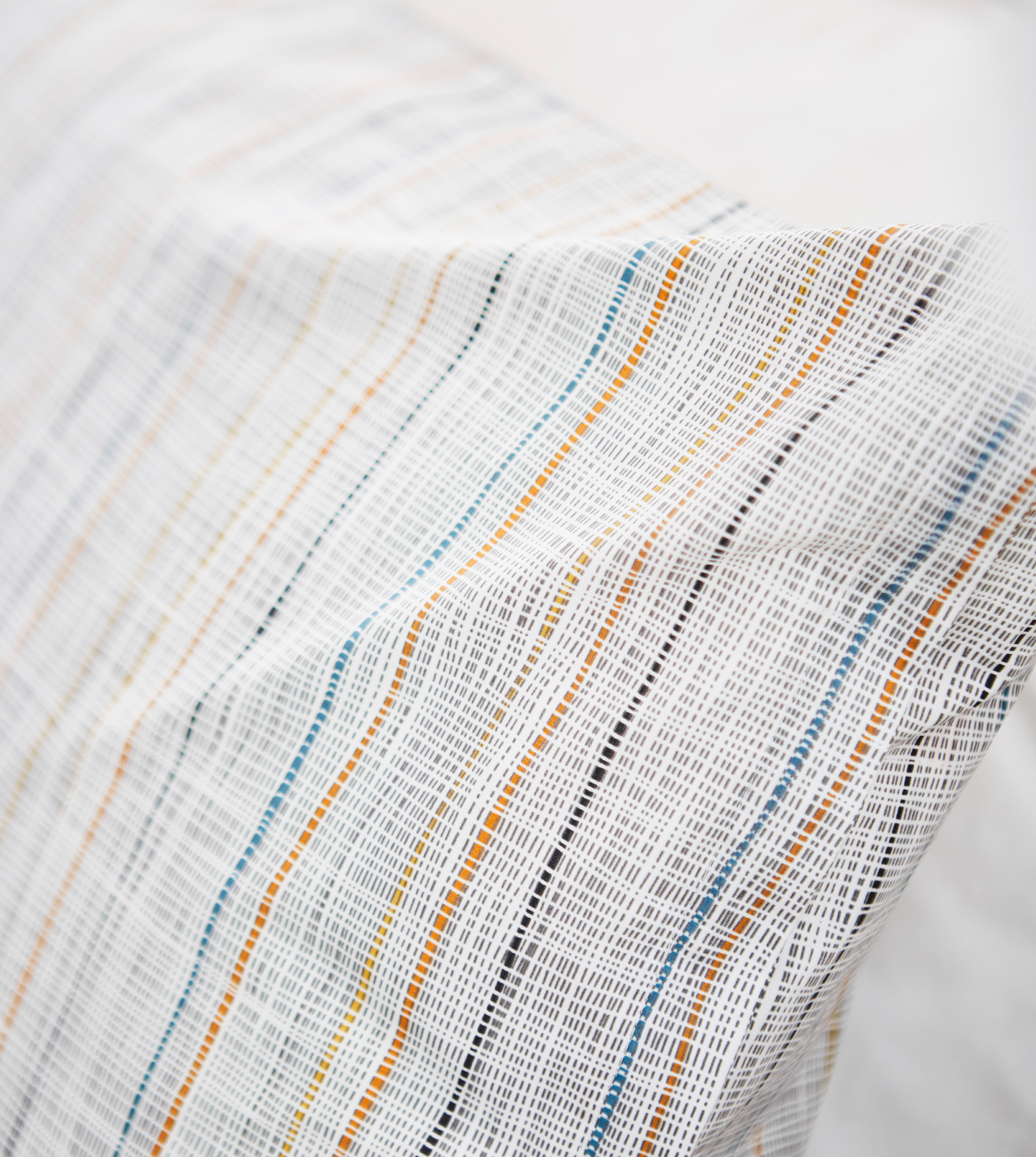 A close-up image of a simple striped pillow.