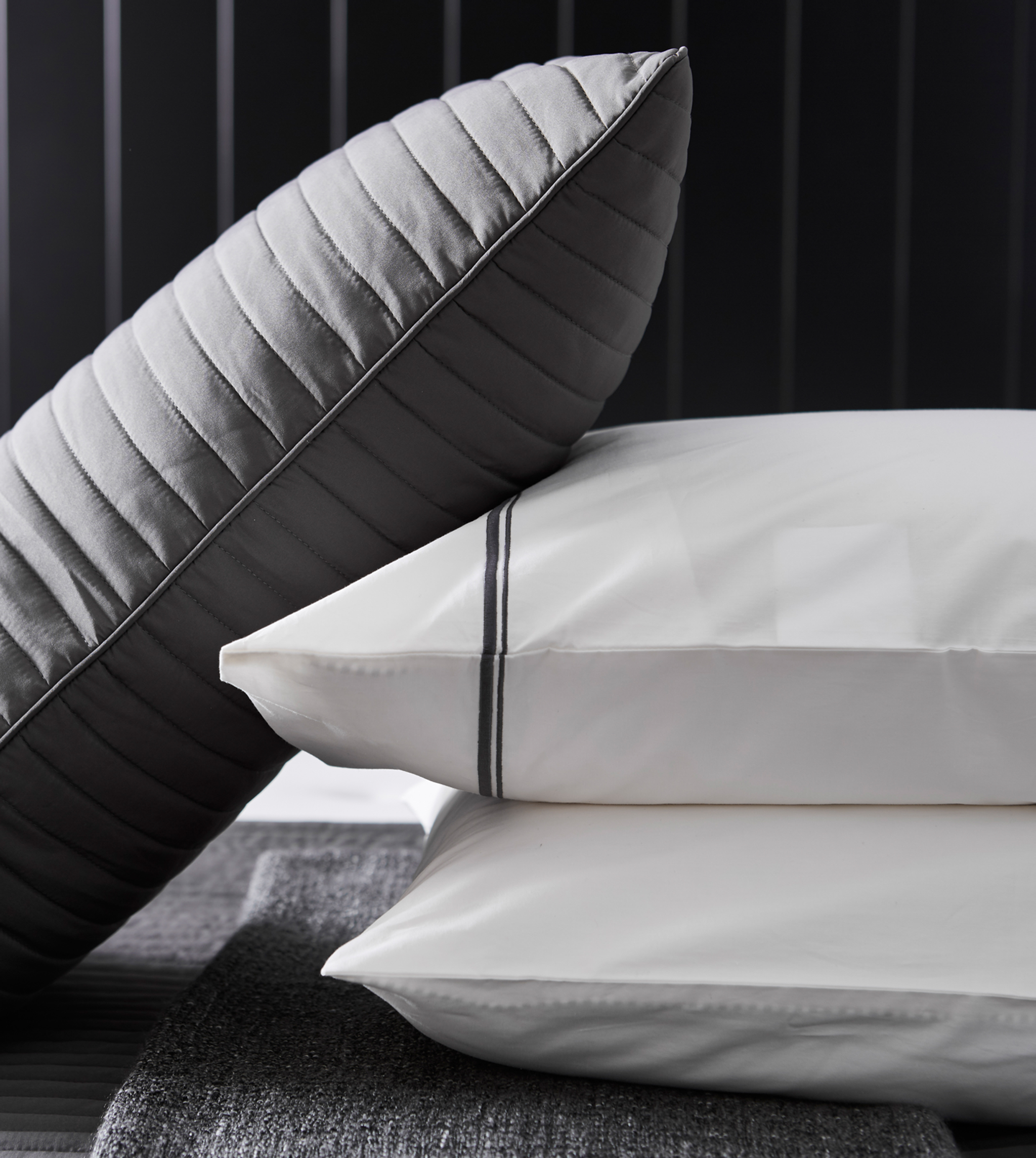 A close-up image of pillows and a cushion.