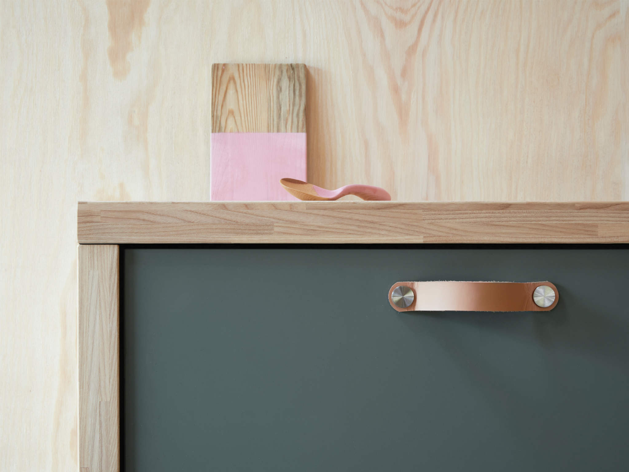 A close-up of a kitchen drawer using BODARP drawer front in a matte grey-green for a modern look.