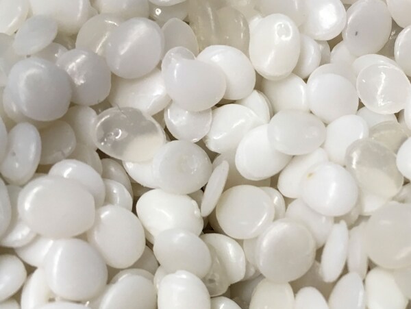 A close-up of white and transparent PLA plastic pellets, made from renewable based materials.