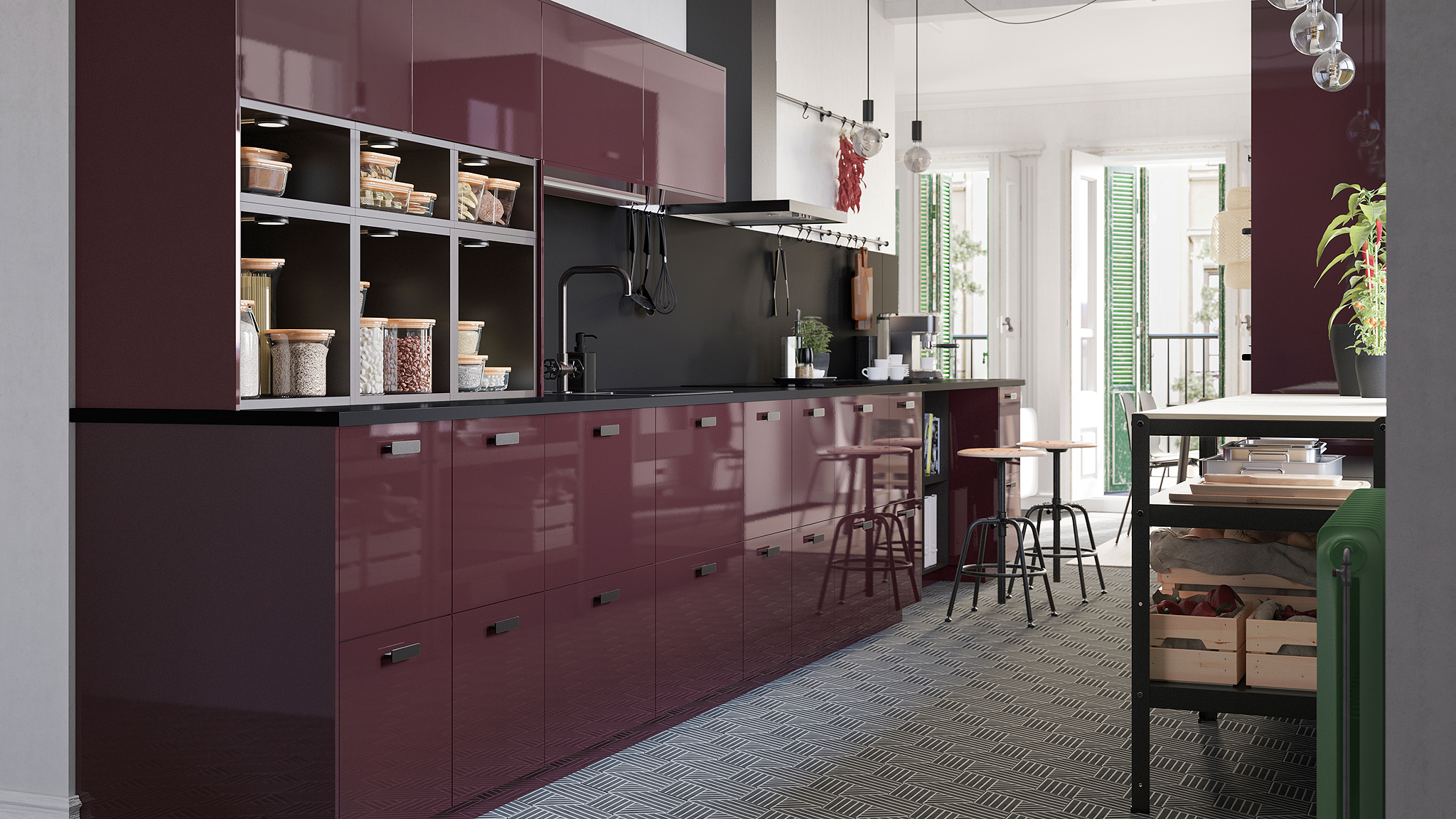 A high-gloss kitchen in burgundy, a hexagon-patterned floor and naked light bulbs on cords that hang from the ceiling.