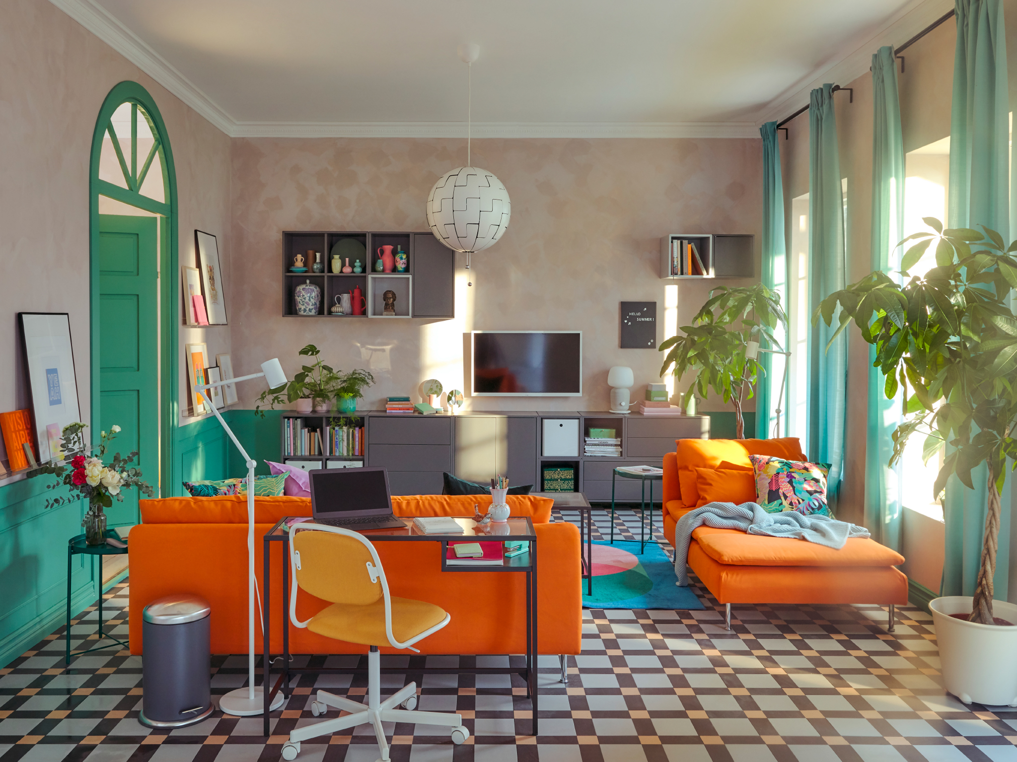 A living room with a scattered daytime arrangement of SÖDERHAMN seating and workspace with a VITTSJÖ laptop table.