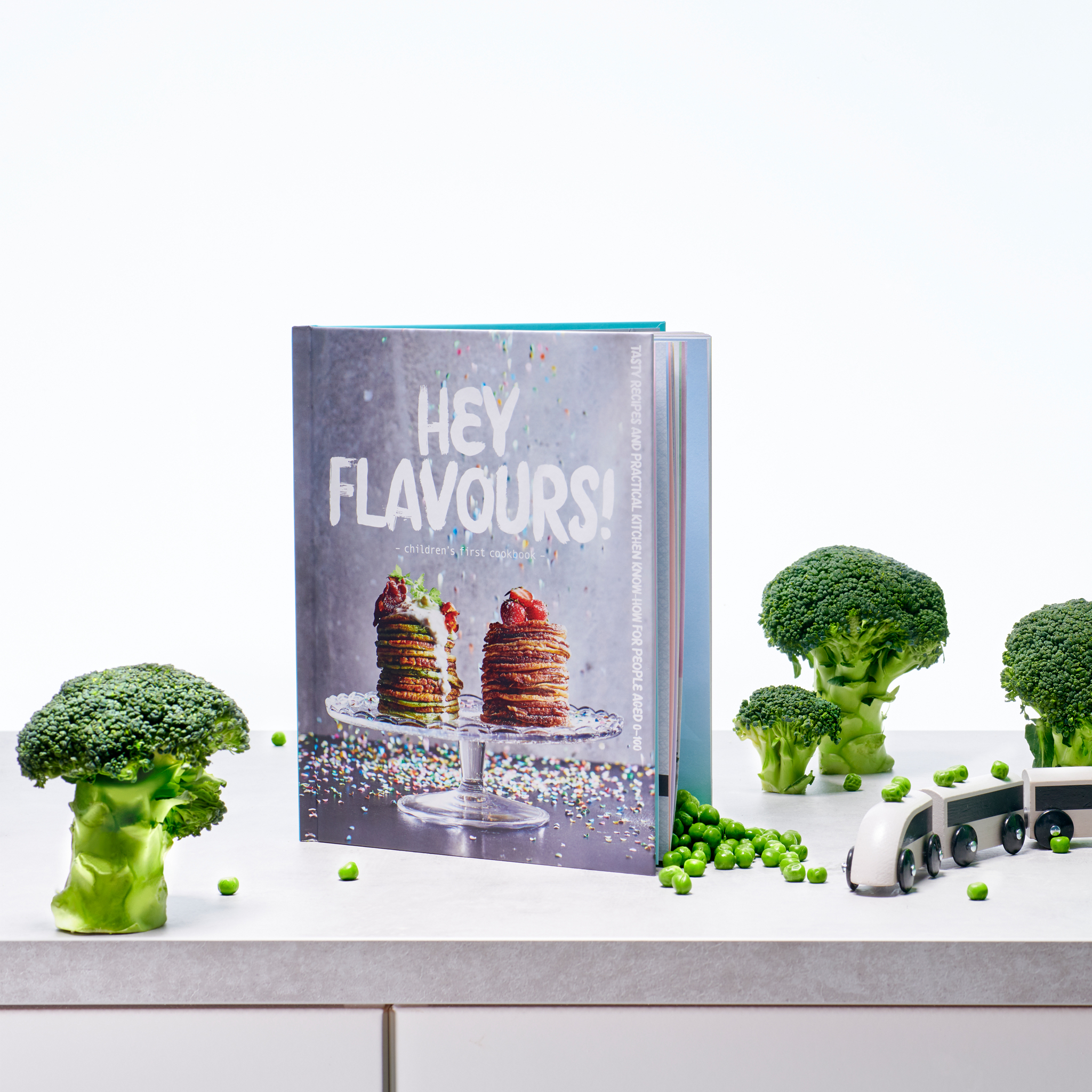 A MATVRÅ book Hey Flavours! with a cover featuring stacked pancakes on a cake stand with berries on top.