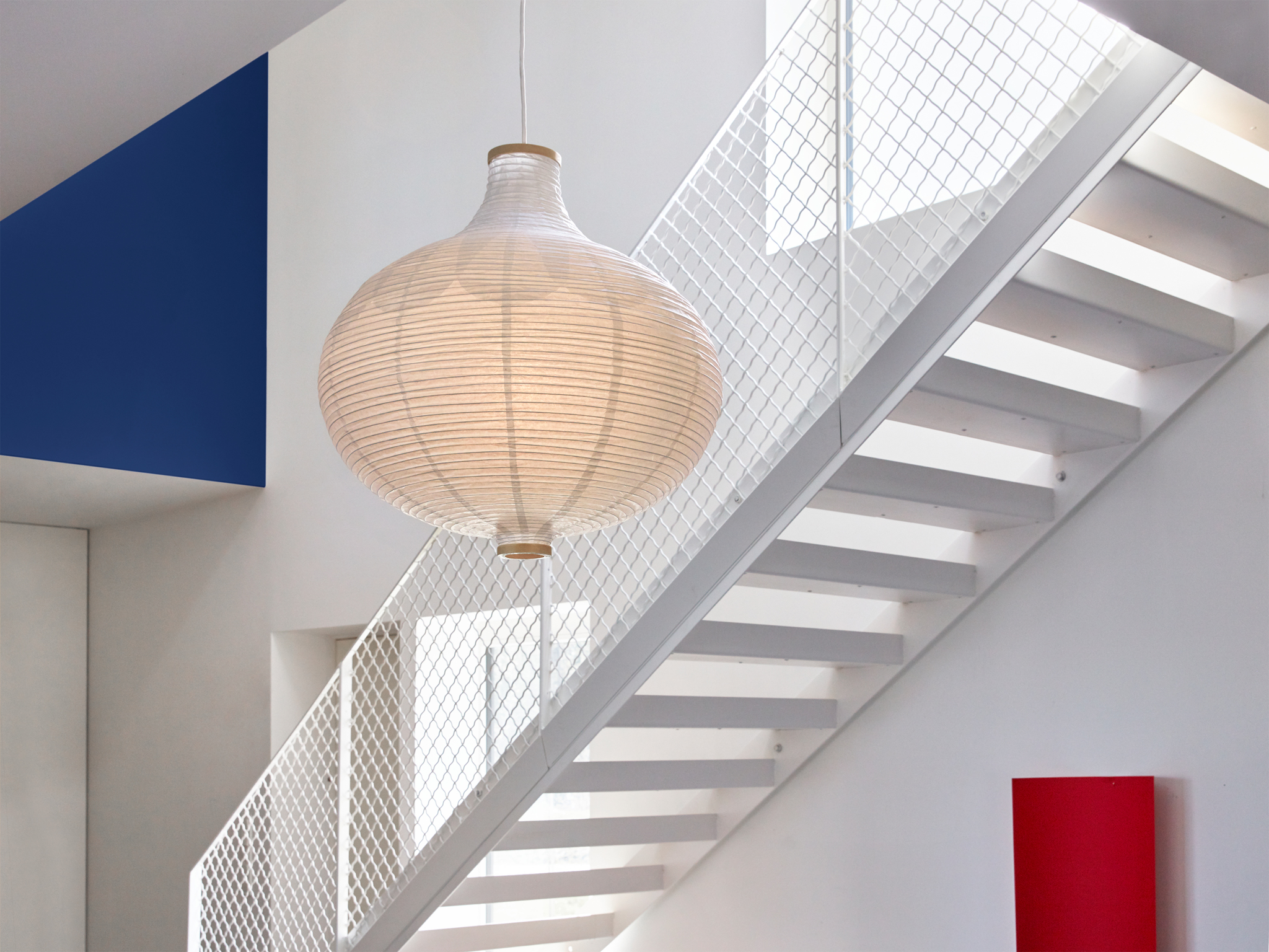 A RISBYN pendant lampshade made in an onion shape with a thin pattern in the rice paper.