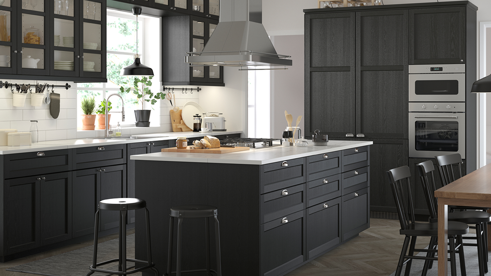 A spacious black and white kitchen in a classic style with stained black LERHYTTAN cabinet doors.