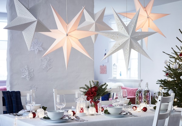 A table prepared for the festive winter season with STRÅLA lighting and VINTERFEST tableware.