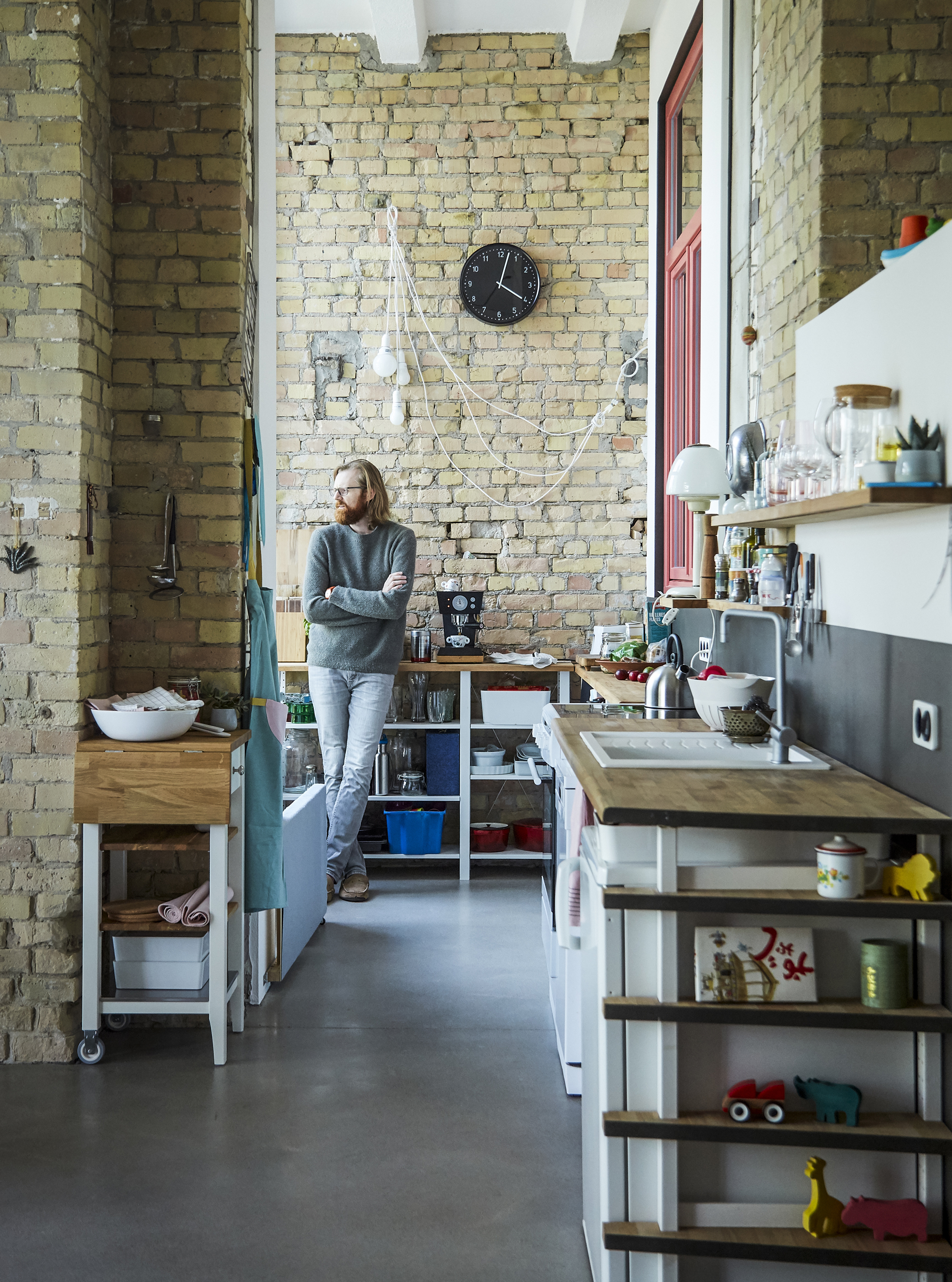 Adam standing in the kitchen with open storage.