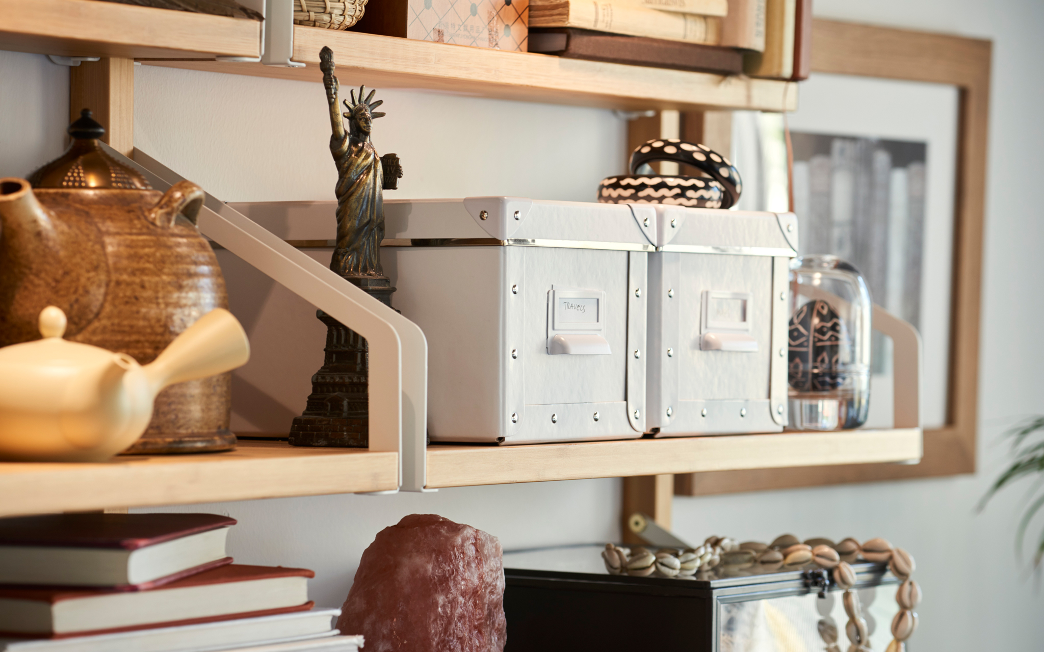 Add a few IKEA FJÄLLA boxes to your shelving to keep smaller items, paper, and more tidy and dust-free.
