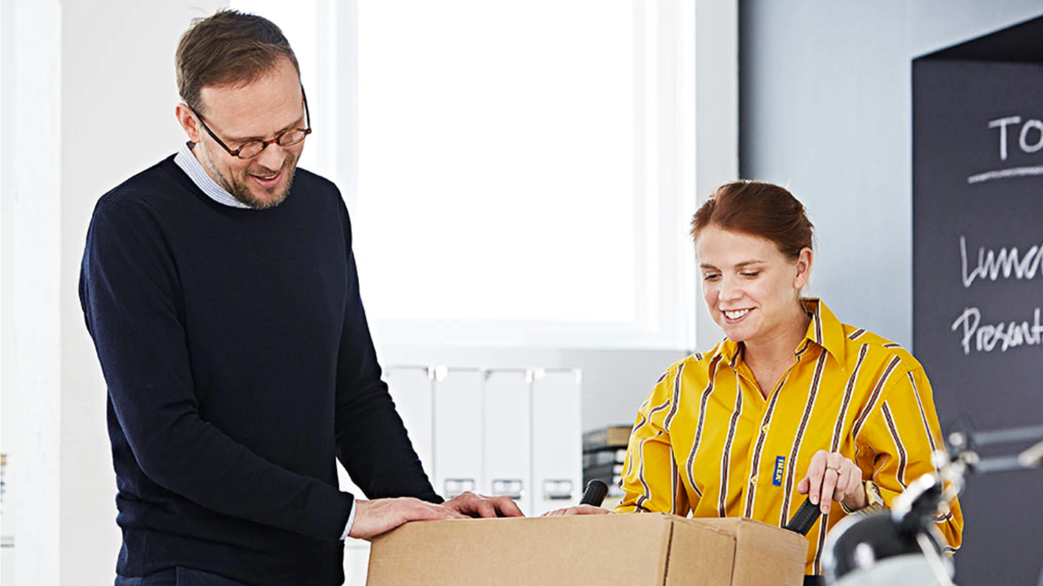 An IKEA employee is introducing the product to the customer
