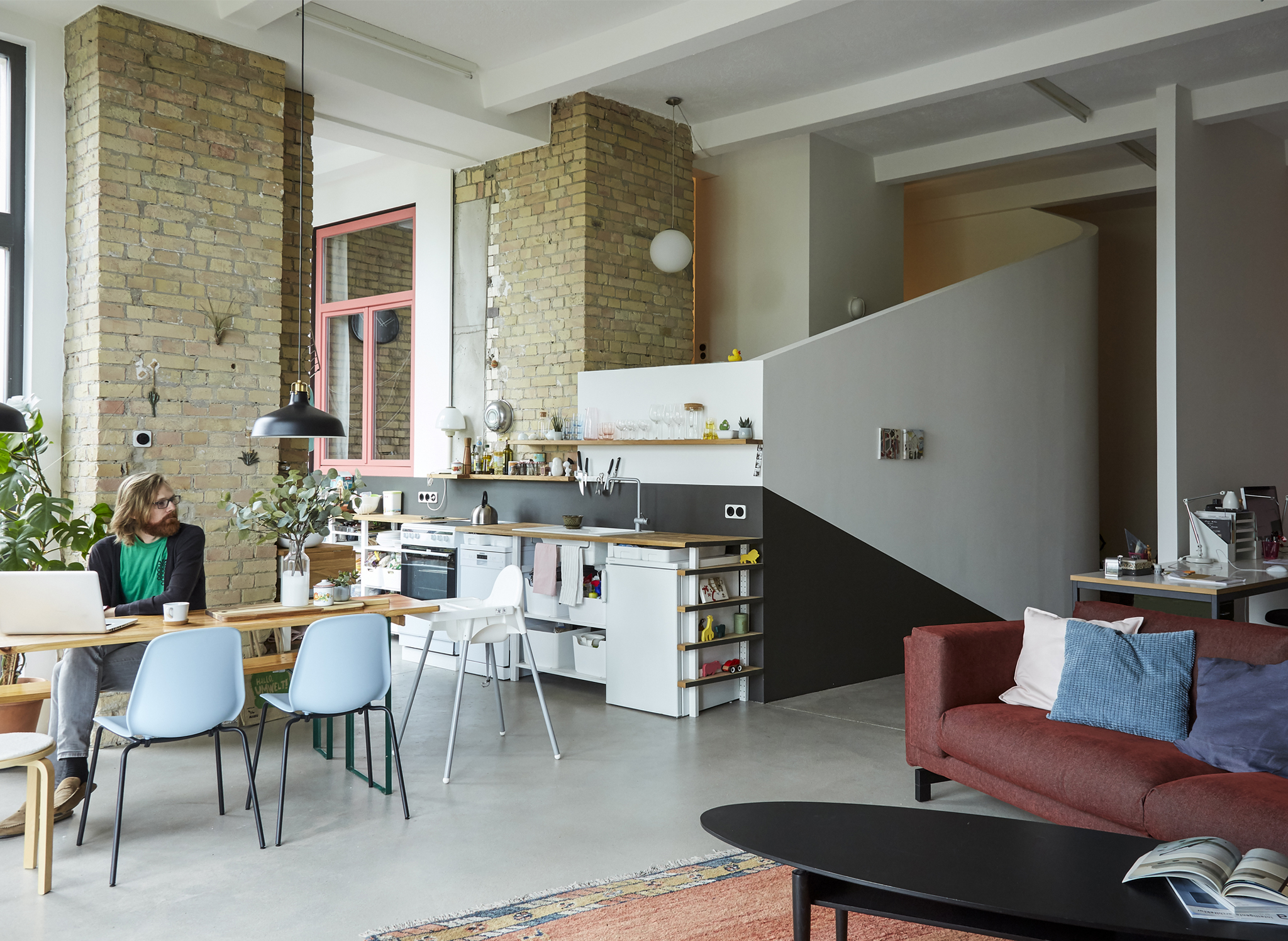 An open-plan living room, kitchen and dining space.