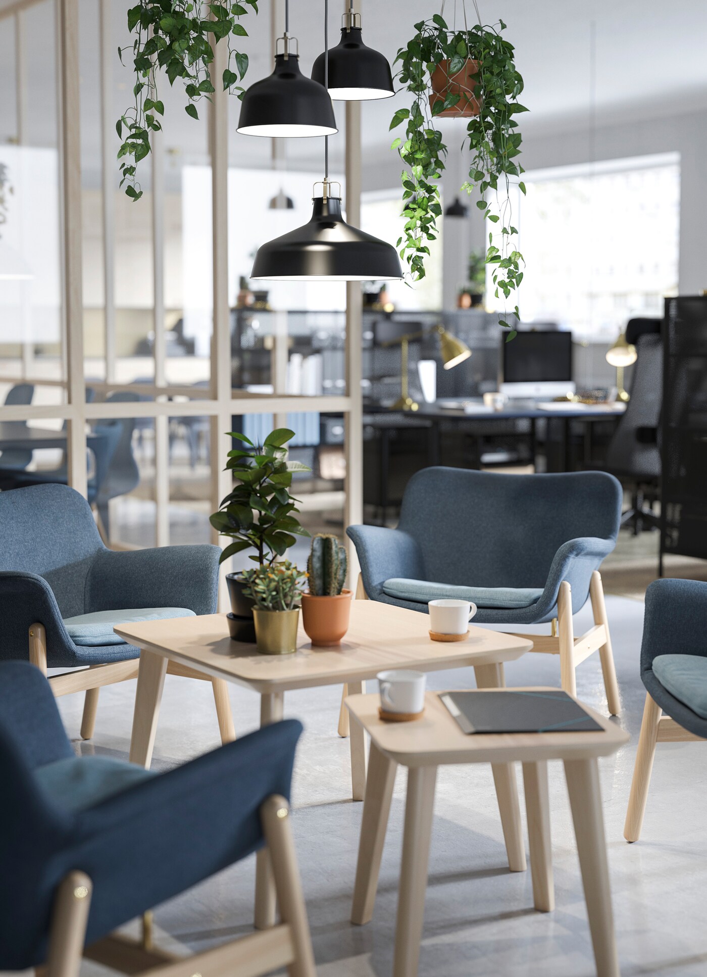 IKEA FOTO pendant lamps, hanging plants and VEDBO sloped blue chairs in a waiting area.