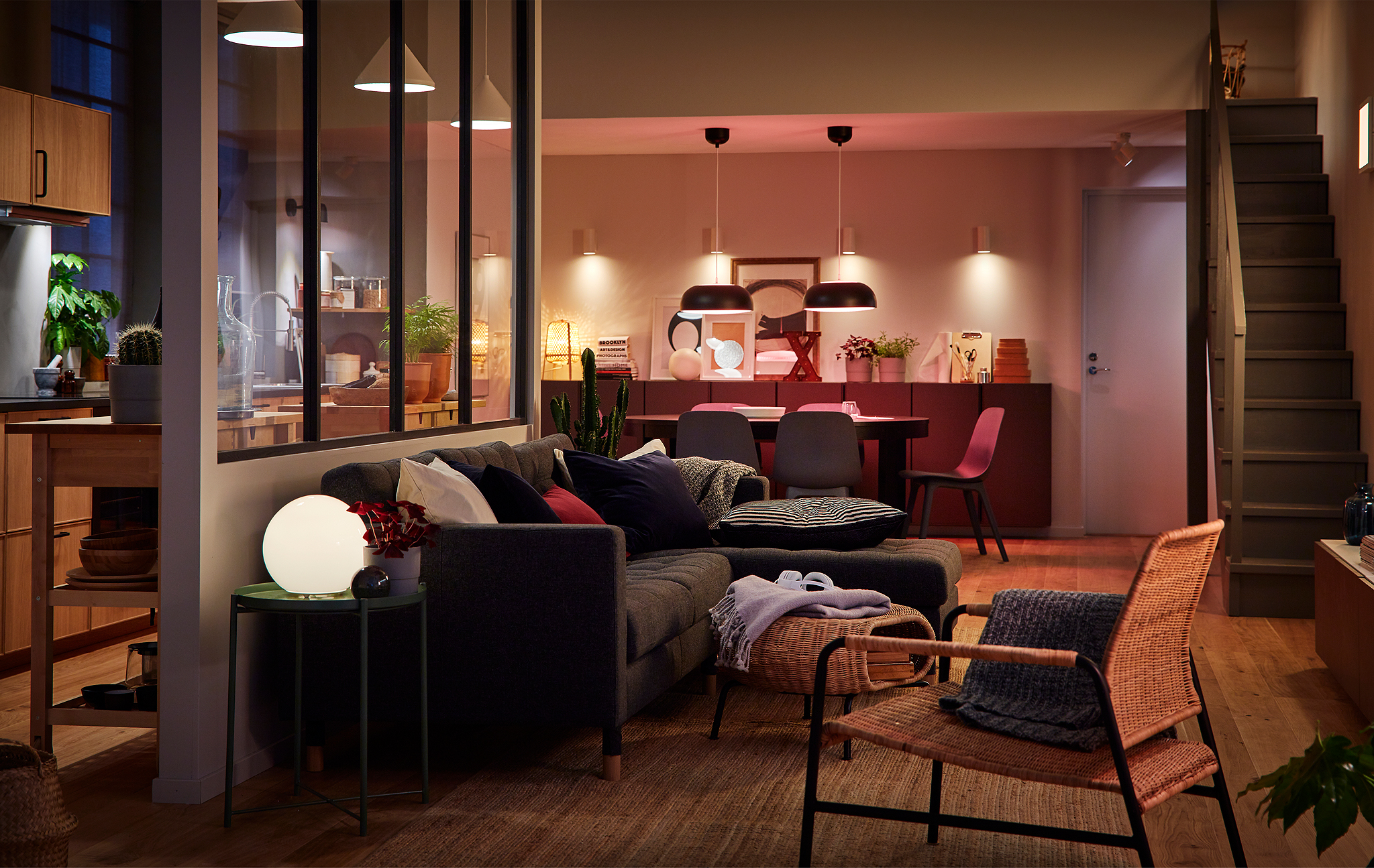 Big room with kitchen, dining area and living room only marginally separated. Room lit with multiple light sources.