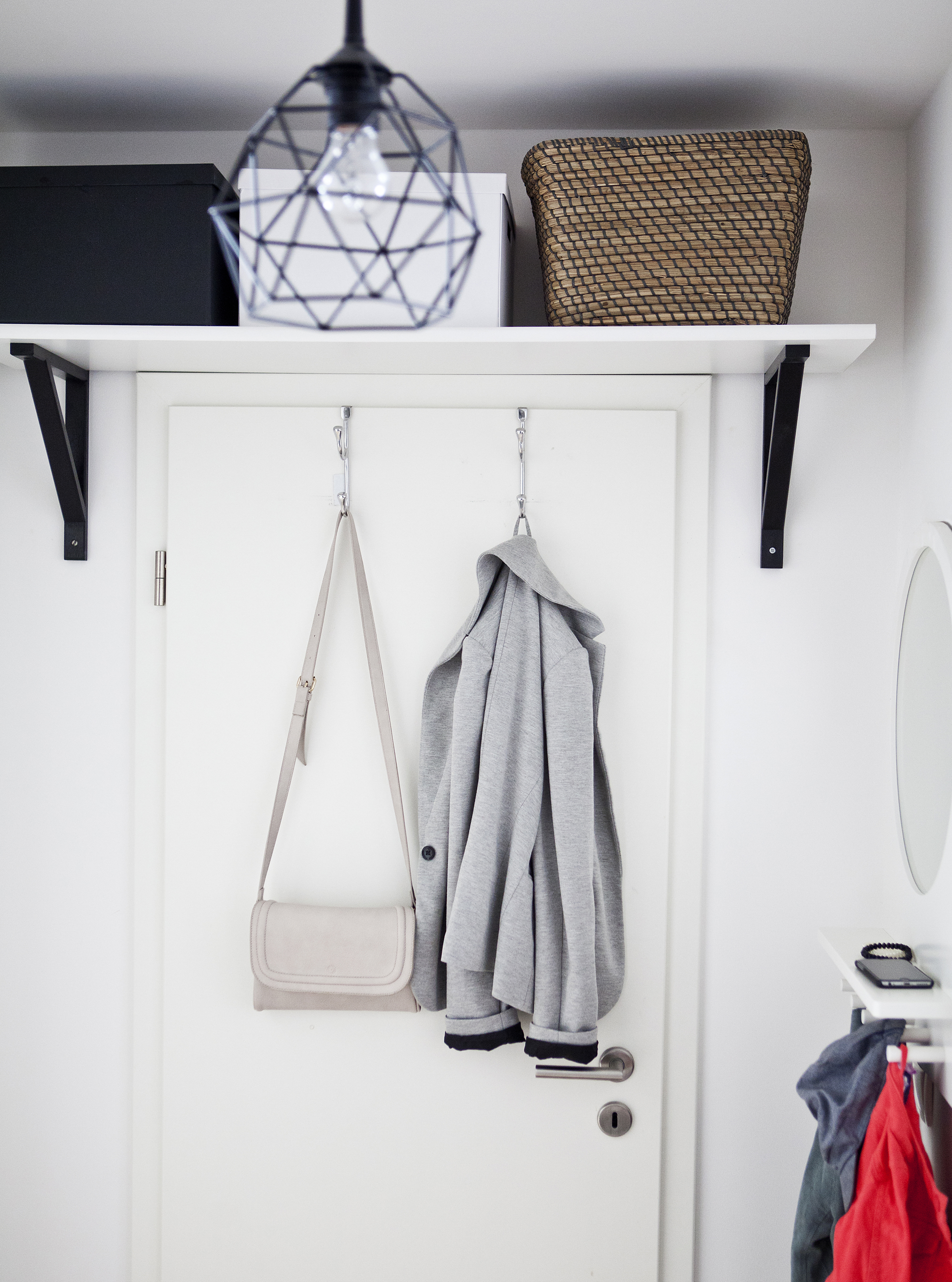 Boxes stored on a shelf above a door.
