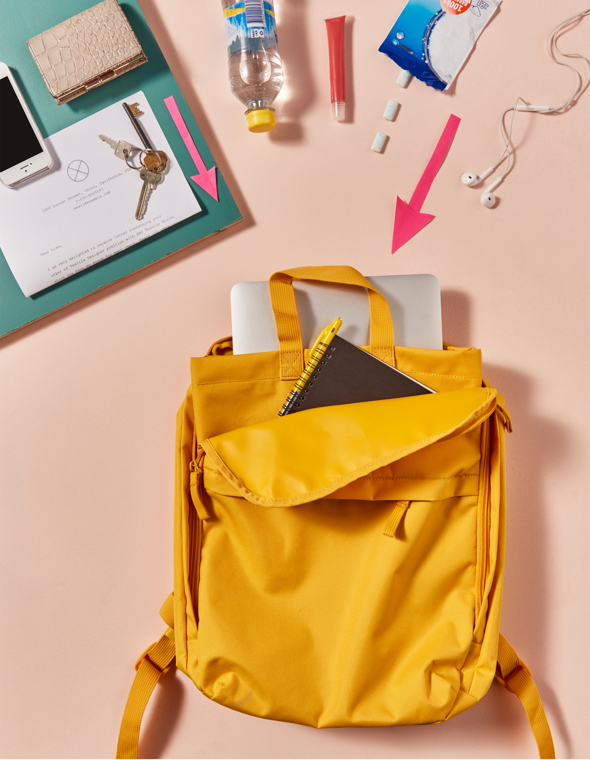 College essentials like a laptop being packed into a backpack