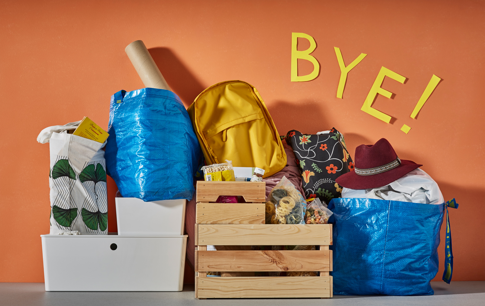 College essentials packed and ready against a coloured wall