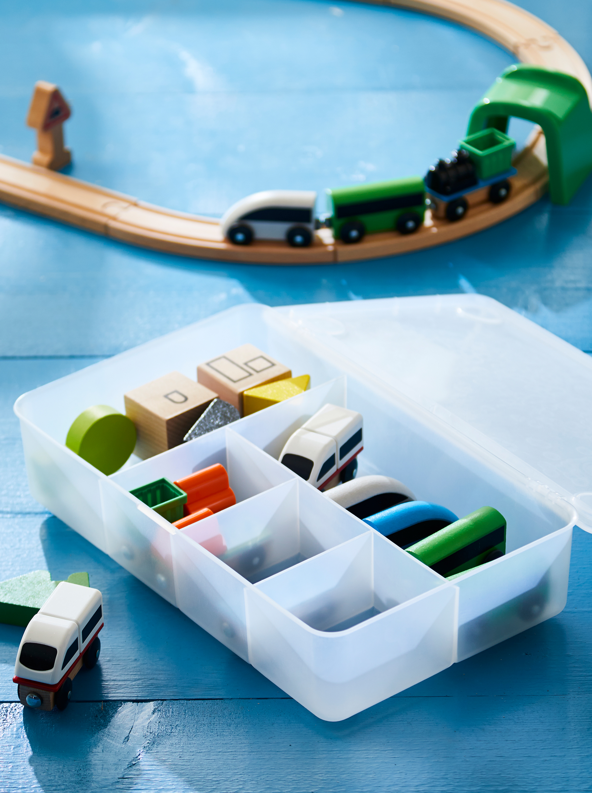 next to the layout is a glis box filled with sorted accessories