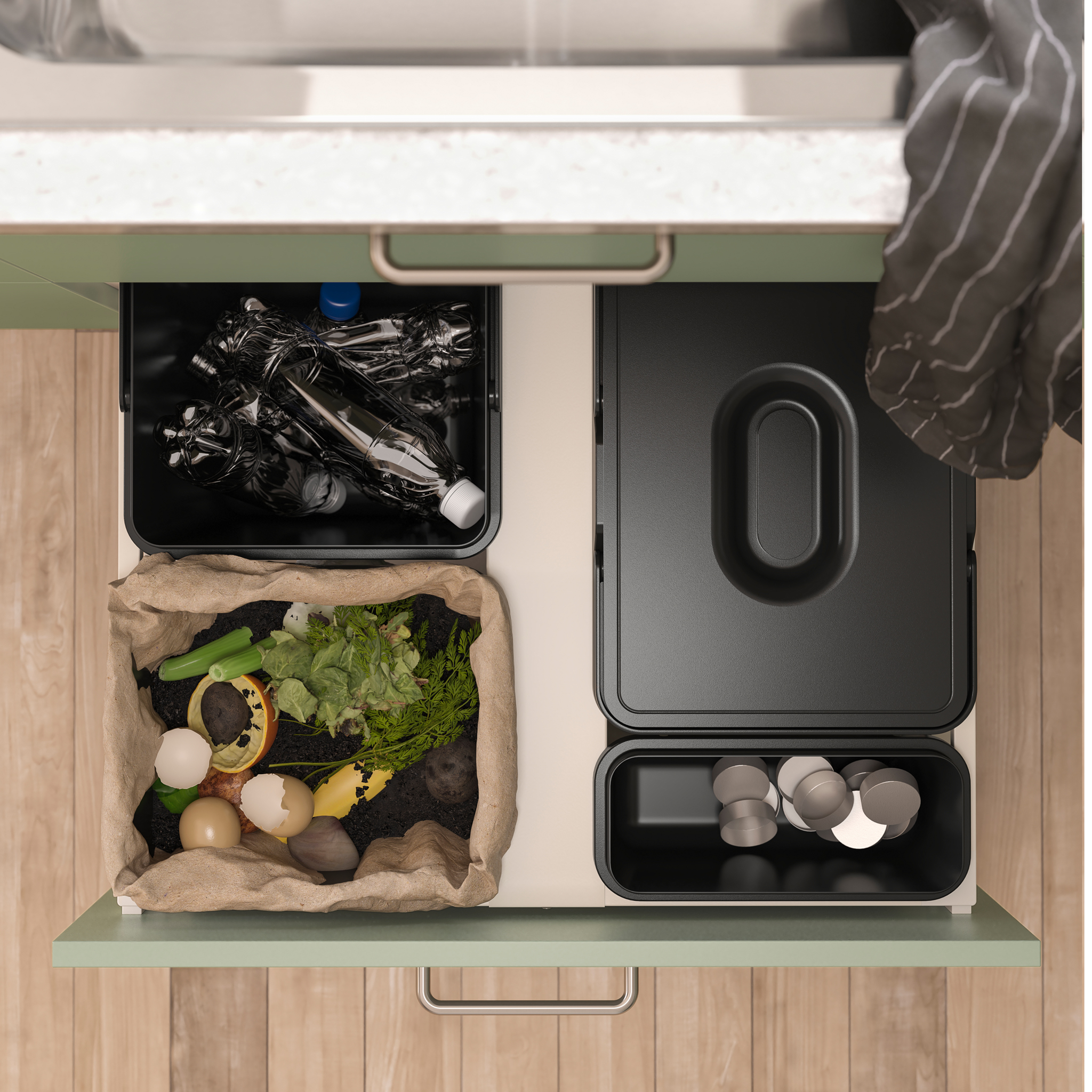 seen from above is an open kitchen drawer with black waste