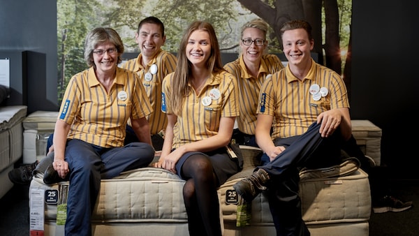 Five IKEA employees sit on the couch