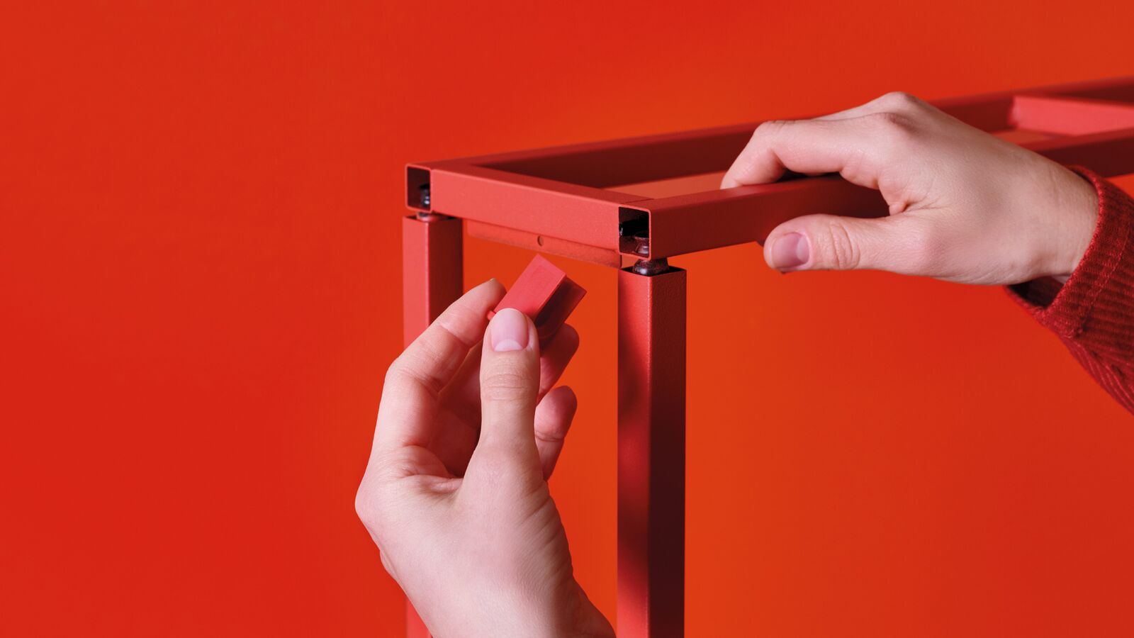 Hands assembling a piece of furniture