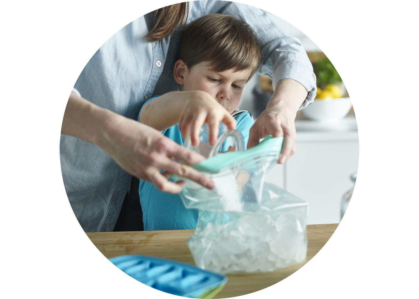 Mother and son are filling a ISTAD plastic bags with ice cubes.