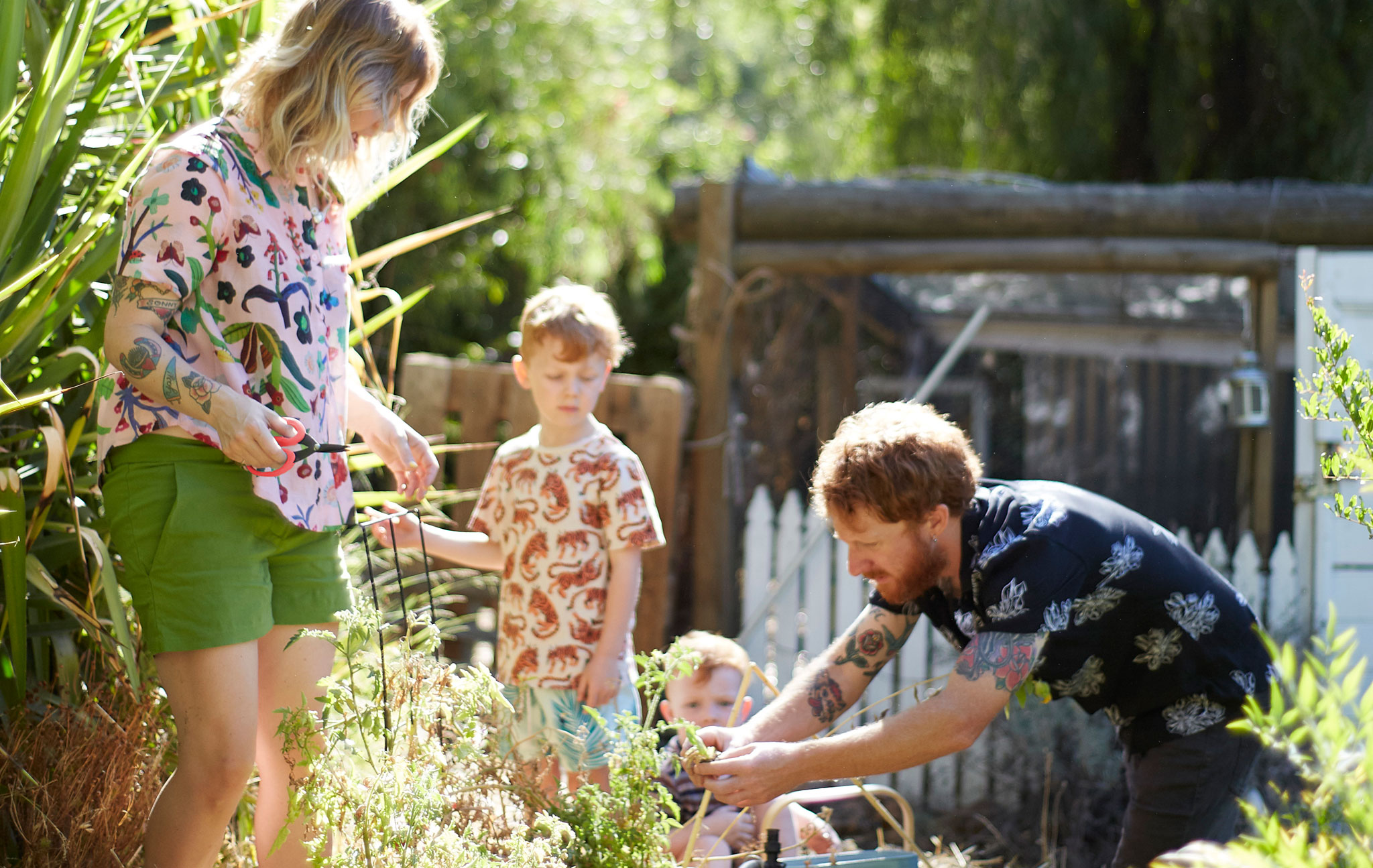 Nici, Ben and their two children working in the garden.