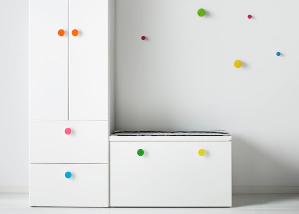 Some STUVA storage system cabinets in white with coloured knobs.