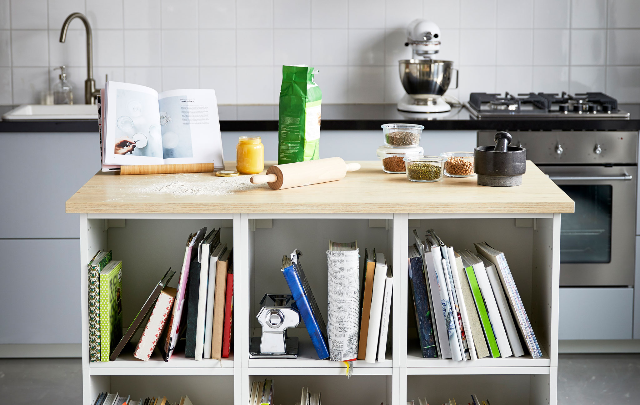 Two images of a kitchen island perfect for baking on and storing your cookbooks and baking tools.