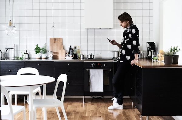 White tiles and furniture brighten kitchens with dark units.